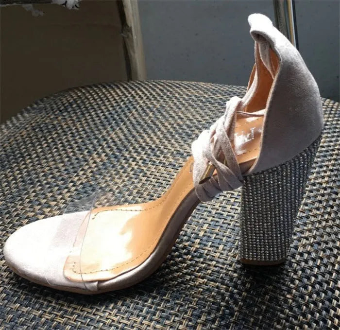 A pair of women's pointed-toe high heels in plastic, shown in black and gold colour options.