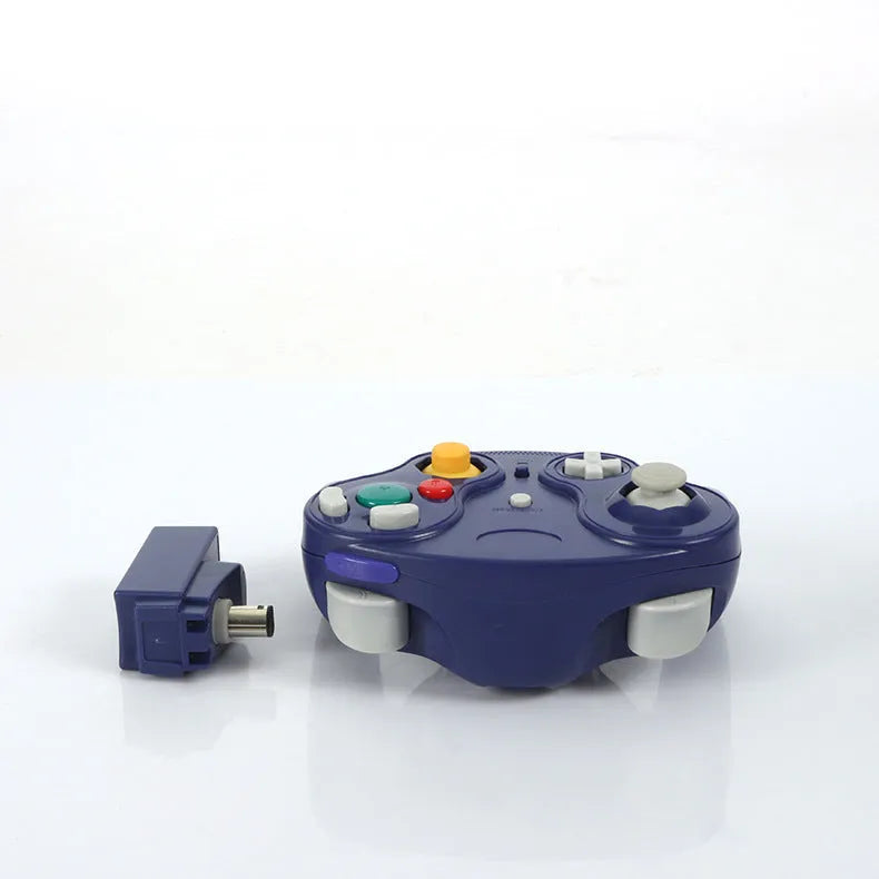 NGC wireless game controller in multiple colours on a grey background, showing its compact size and button layout.