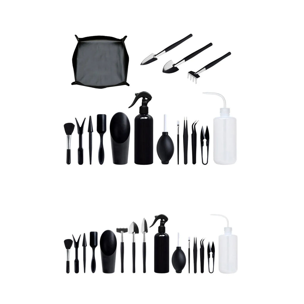 Black mini garden hand tools set for succulents with tweezers, shovels, watering bottle, brushes, and a grey cushion.