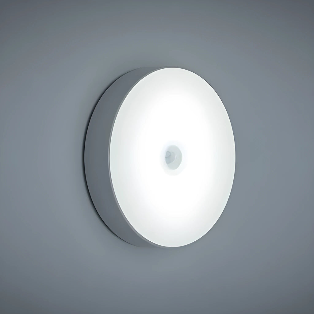 White circular motion sensor night light with USB charging port showing 86mm diameter dimensions