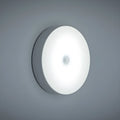 White circular motion sensor night light with USB charging port showing 86mm diameter dimensions