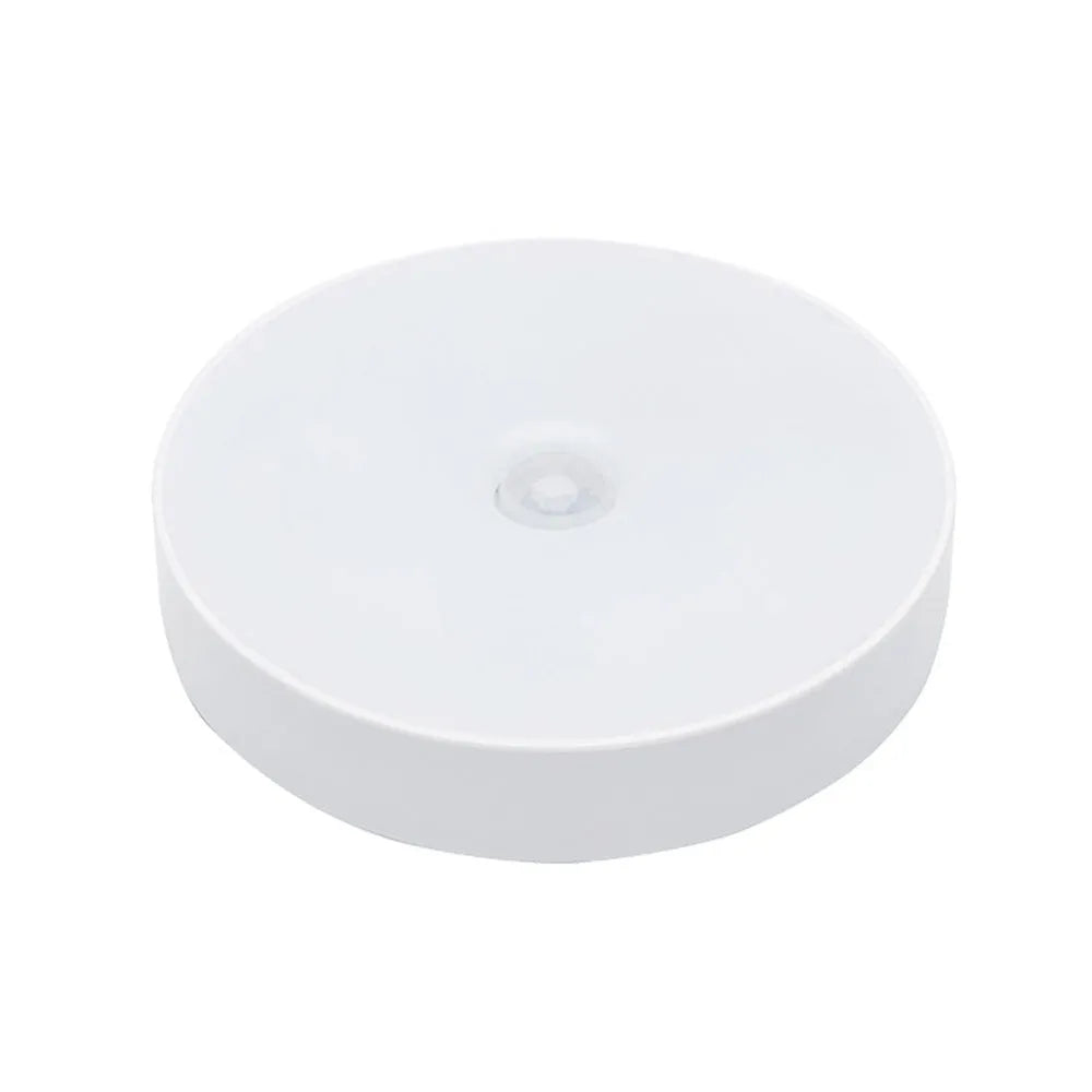 White circular motion sensor night light with USB charging port showing 86mm diameter dimensions