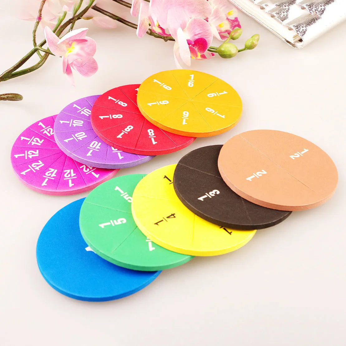 Plastic fraction teaching aids set with magnetic blocks, discs, transparent films, and rulers on a base.