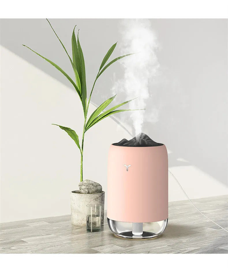 White Magic Flame columnar humidifier with USB cable on a desk