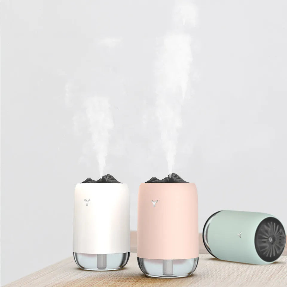White Magic Flame columnar humidifier with USB cable on a desk