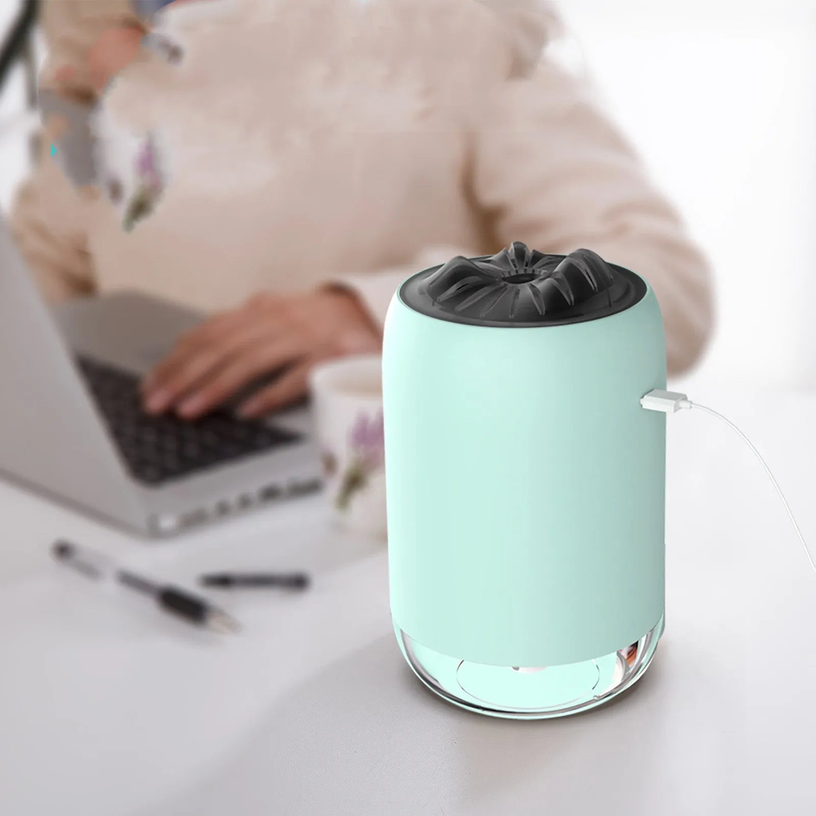 White Magic Flame columnar humidifier with USB cable on a desk