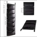 Vertical felt wall garden planter with multiple planting pockets hanging on outdoor wall