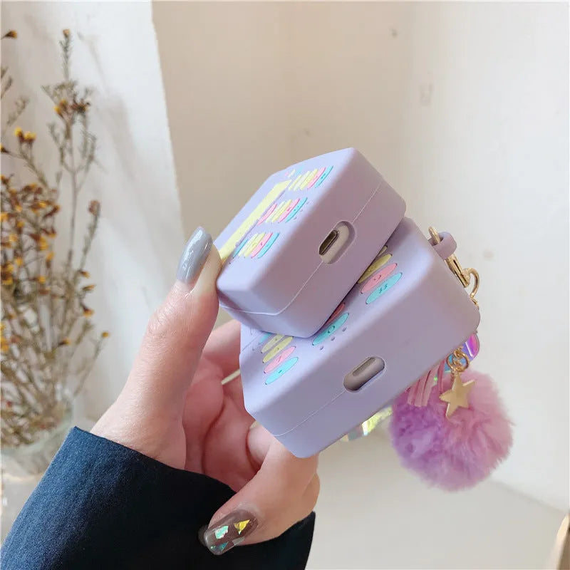 Purple silicone AirPods case with fur ball pendant, clamshell design for AirPods Pro and AirPods 1/2 models