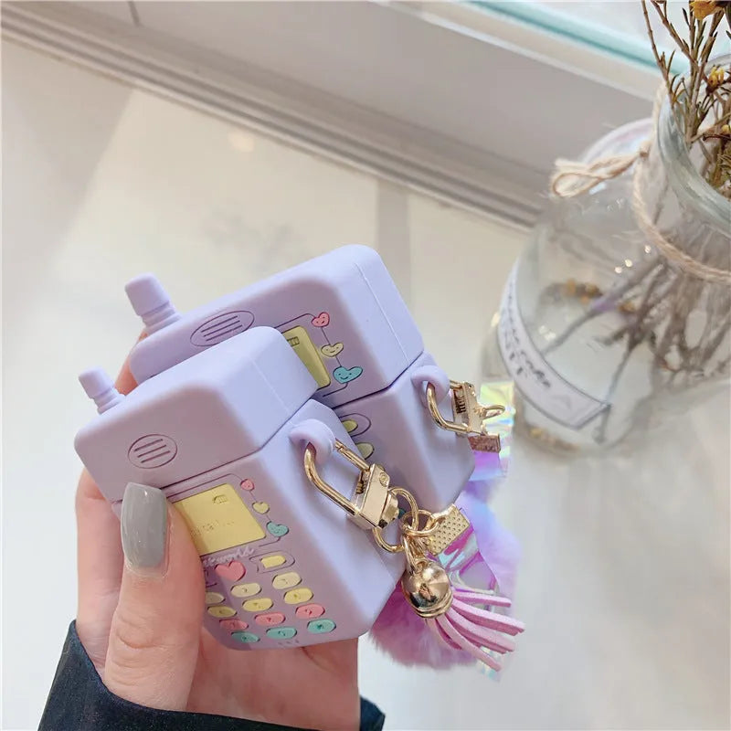 Purple silicone AirPods case with fur ball pendant, clamshell design for AirPods Pro and AirPods 1/2 models