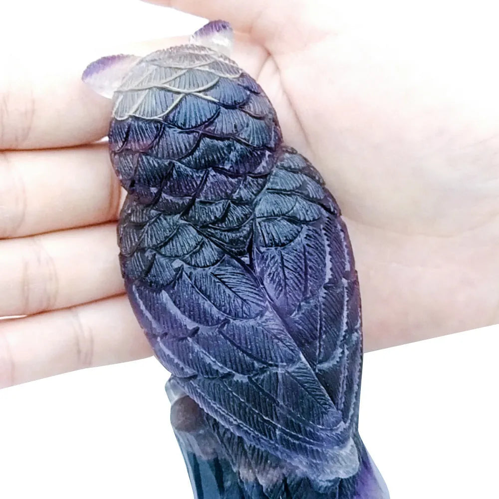 Purple fluorite carved owl ornament approximately 4 inches tall on display surface