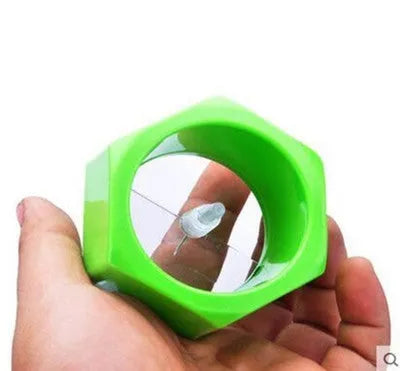 Yellow and green plastic spiral vegetable cutter for kitchen use.