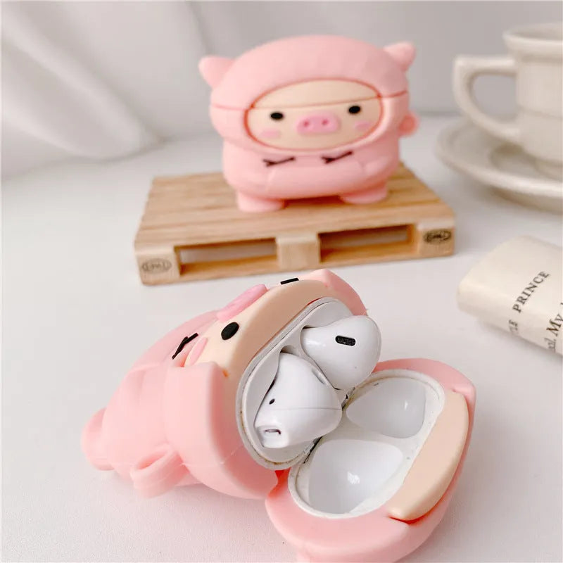 Silicone AirPods case cover with cartoon pig design in pink colour showing flip closure and keychain hook