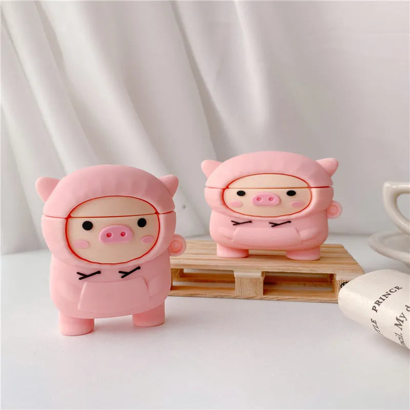 Silicone AirPods case cover with cartoon pig design in pink colour showing flip closure and keychain hook