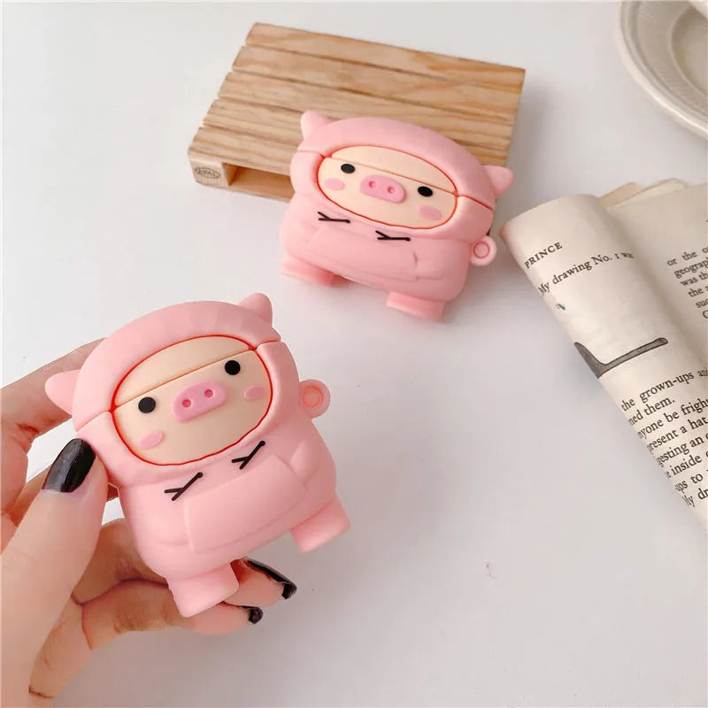 Silicone AirPods case cover with cartoon pig design in pink colour showing flip closure and keychain hook