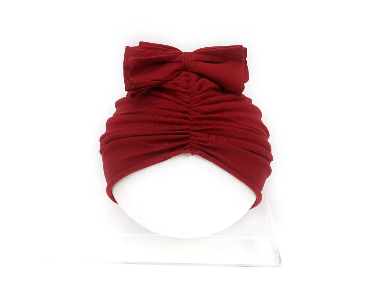 Soft knitted acrylic baby girl turban hat in various colours fitting 0-28 months