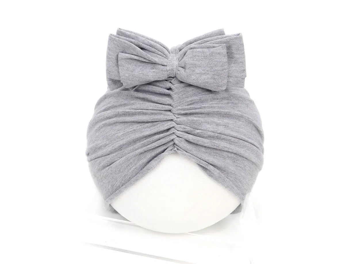 Soft knitted acrylic baby girl turban hat in various colours fitting 0-28 months