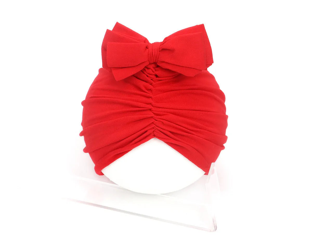 Soft knitted acrylic baby girl turban hat in various colours fitting 0-28 months