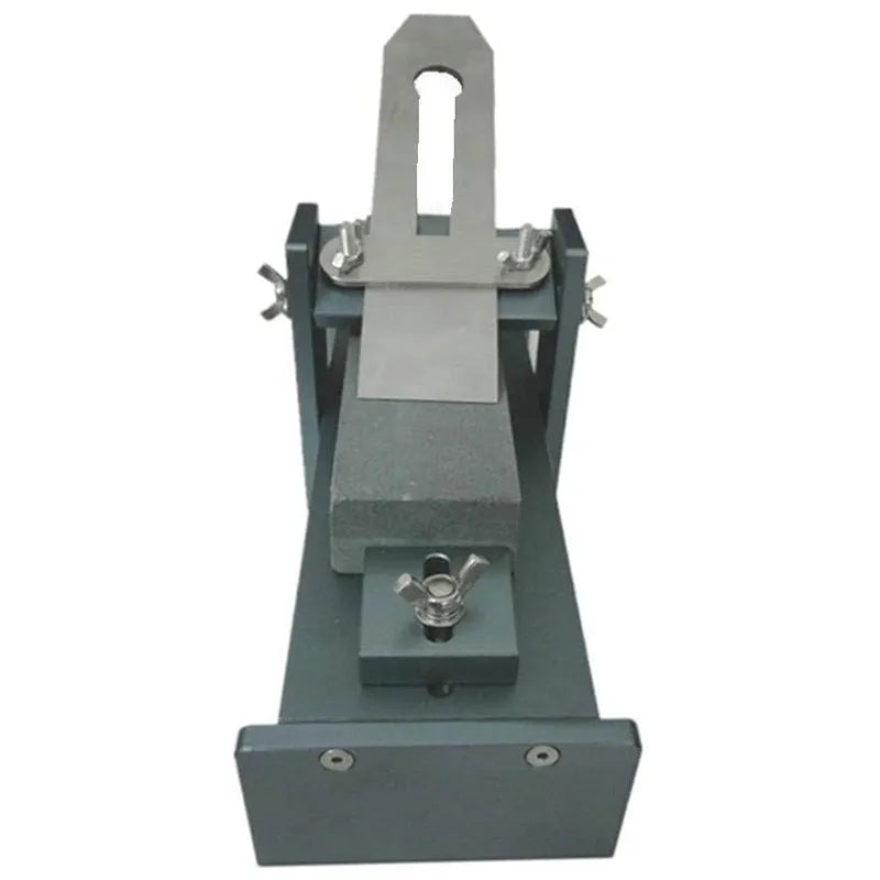 Aluminium fixed angle gantry sharpening tool for woodworking chisels, planers, and carving knives on a workbench.