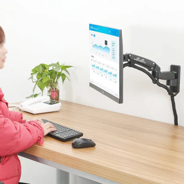 Black wall-mounted computer monitor stand with telescopic lifting arm and rotating VESA mount plate.