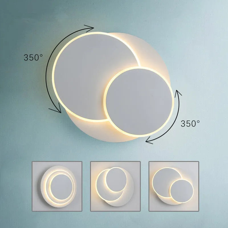 Modern round acrylic LED wall lamp in black or white finish, available in three diameter sizes