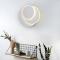 Modern round acrylic LED wall lamp in black or white finish, available in three diameter sizes