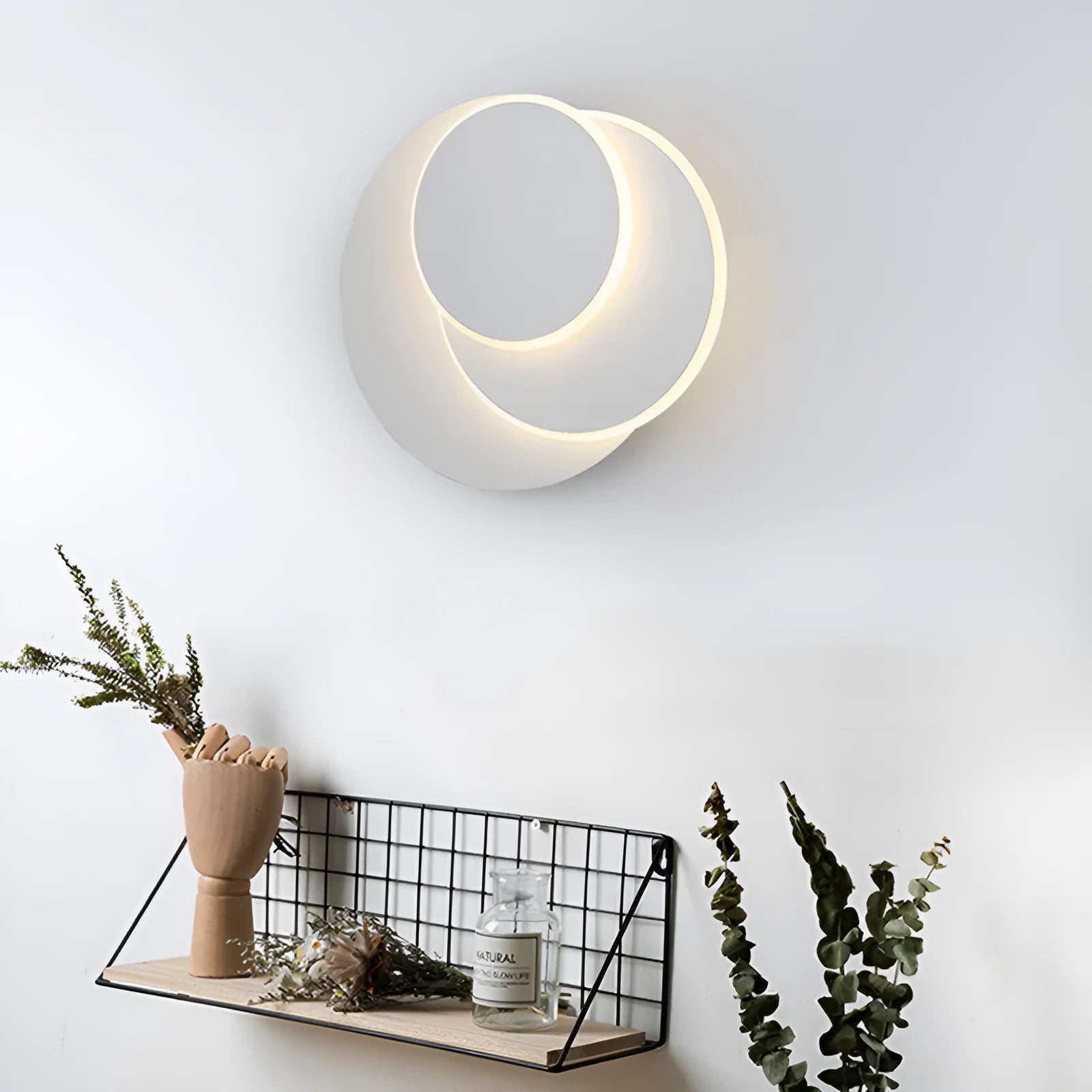Modern round acrylic LED wall lamp in black or white finish, available in three diameter sizes