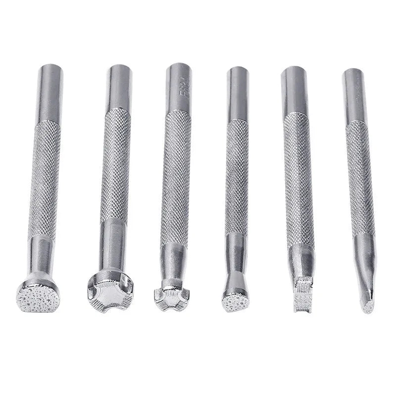 Set of six alloy leather carving printing sticks arranged on a workbench, tools for stamping and embossing