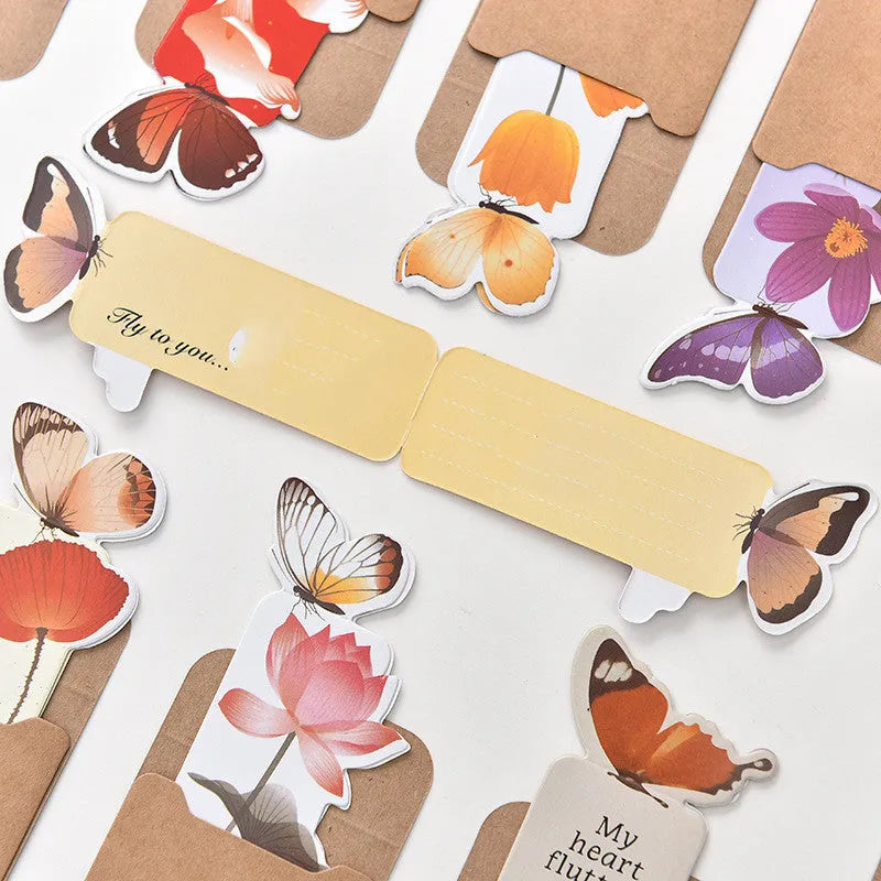 Butterfly-shaped paper bookmark with random colour design for gifting and stationery use.