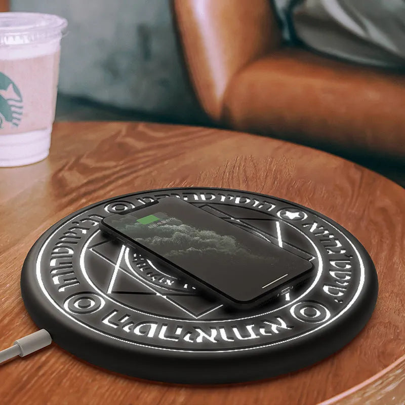 Square wireless charger with glowing magic array pattern design showing phone charging placement