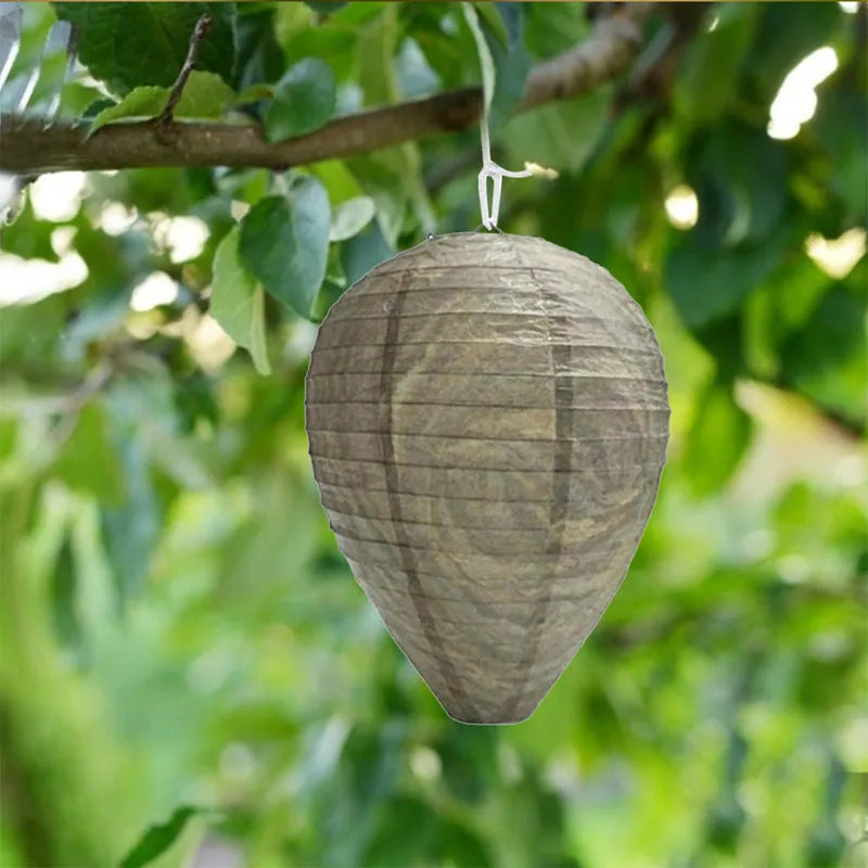 Gold beehive shaped paper lantern with honeycomb texture, shown hanging.