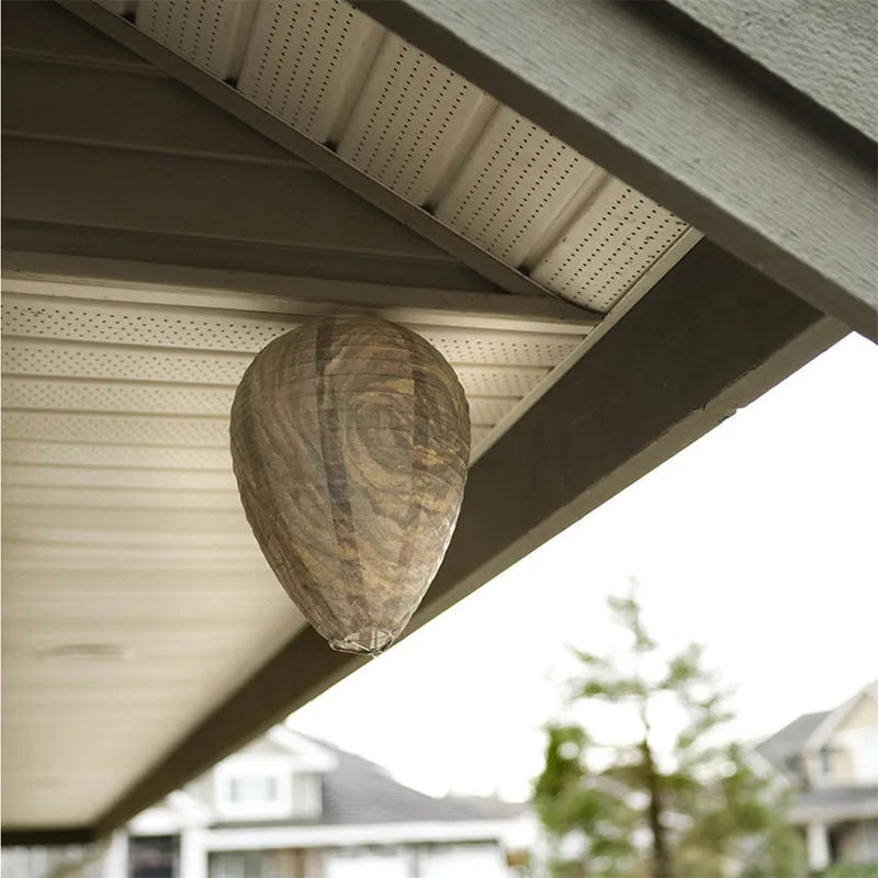 Gold beehive shaped paper lantern with honeycomb texture, shown hanging.