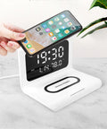 White wireless charger alarm clock displaying time, calendar, temperature and humidity with 10W charging capability