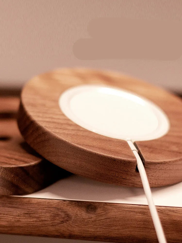 Walnut wood MagSafe wireless charging bracket stand for iPhone on a desk