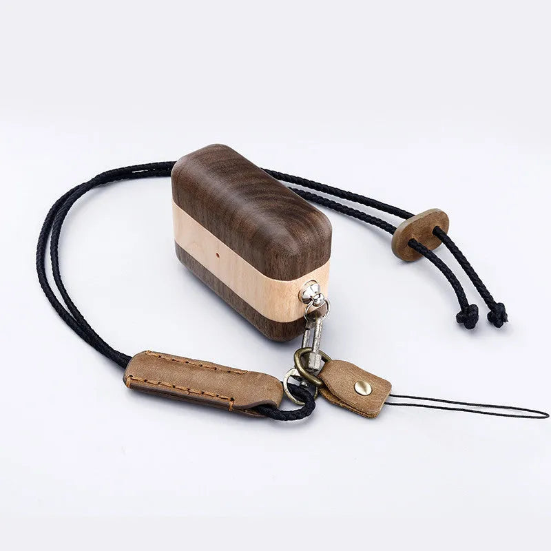 Hardwood Bluetooth earphone sleeve in a choice of wood types next to wireless earphones.