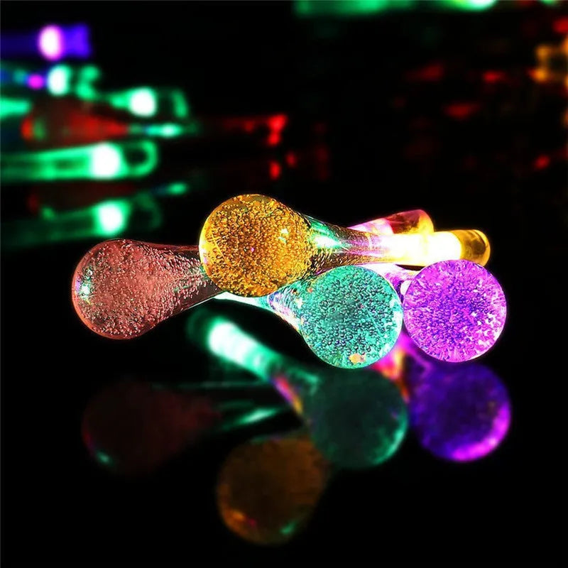 Solar-powered outdoor LED string lights with water drop pendants on 6.5 metre cable