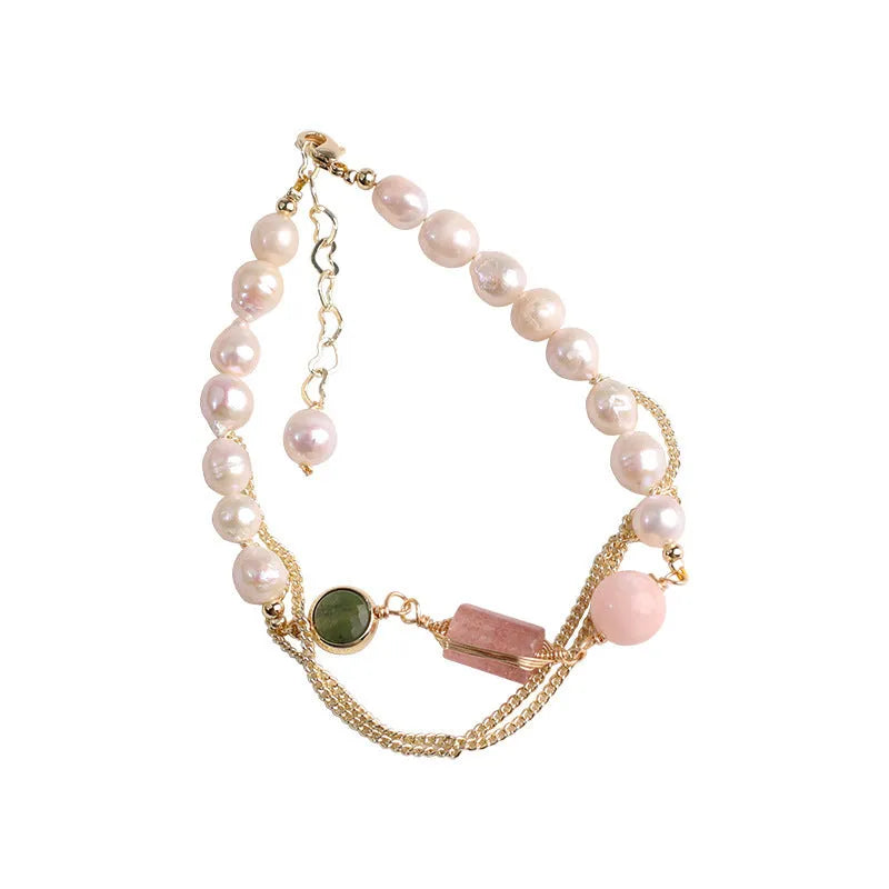 Pink women's bracelet with natural freshwater pearls and a strawberry crystal charm on a geometric design.