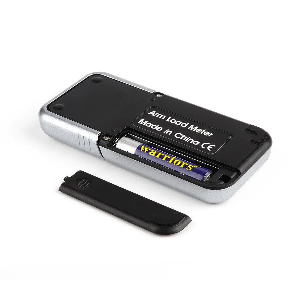 Compact black electronic gram scale with digital display on a table.