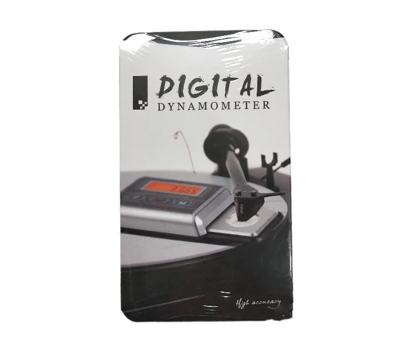 Compact black electronic gram scale with digital display on a table.