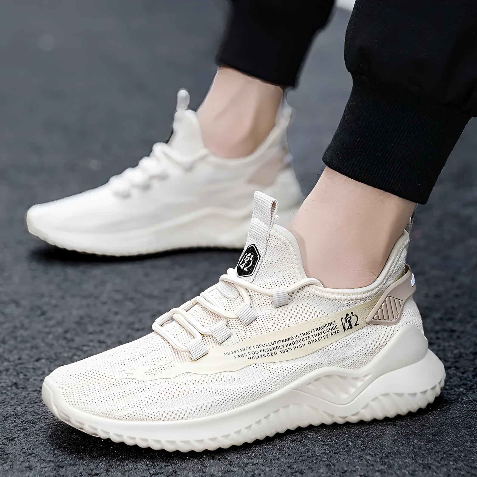 Men's white low-top sports shoes with mesh upper and rubber sole on neutral background