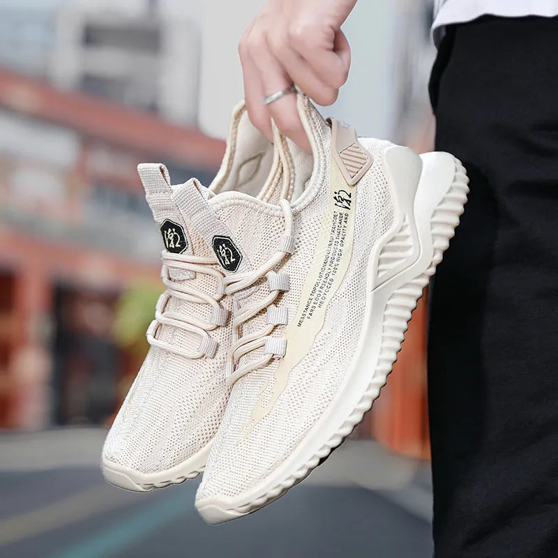 Men's white low-top sports shoes with mesh upper and rubber sole on neutral background