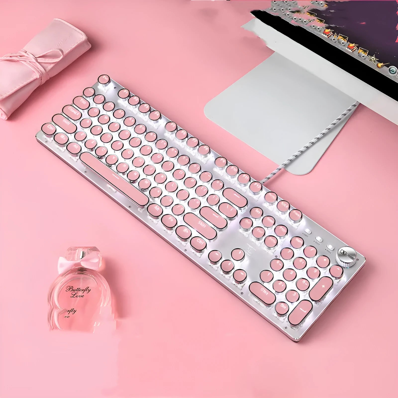Silver and pink mechanical keyboard with green switches and white backlight alongside wired mouse