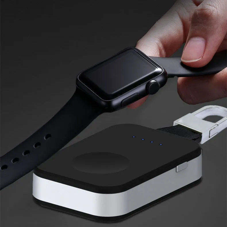 Black Apple Watch portable wireless power bank on a keyring showing compact size