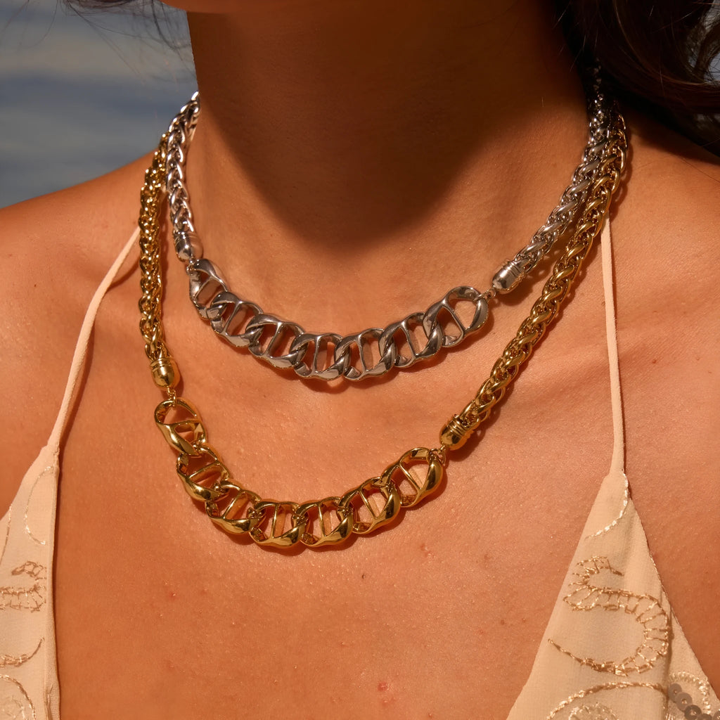 Stainless steel geometric pendant necklace with gold plating on a regular chain.