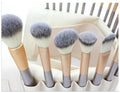 Persian makeup brush set with champagne handles and white bristles arranged in 12, 18, and 24 brush options.