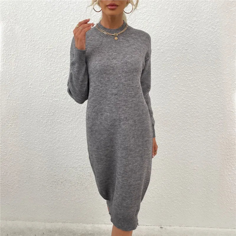 Grey women's crew neck long sleeve acrylic pullover sweater dress on a hanger.