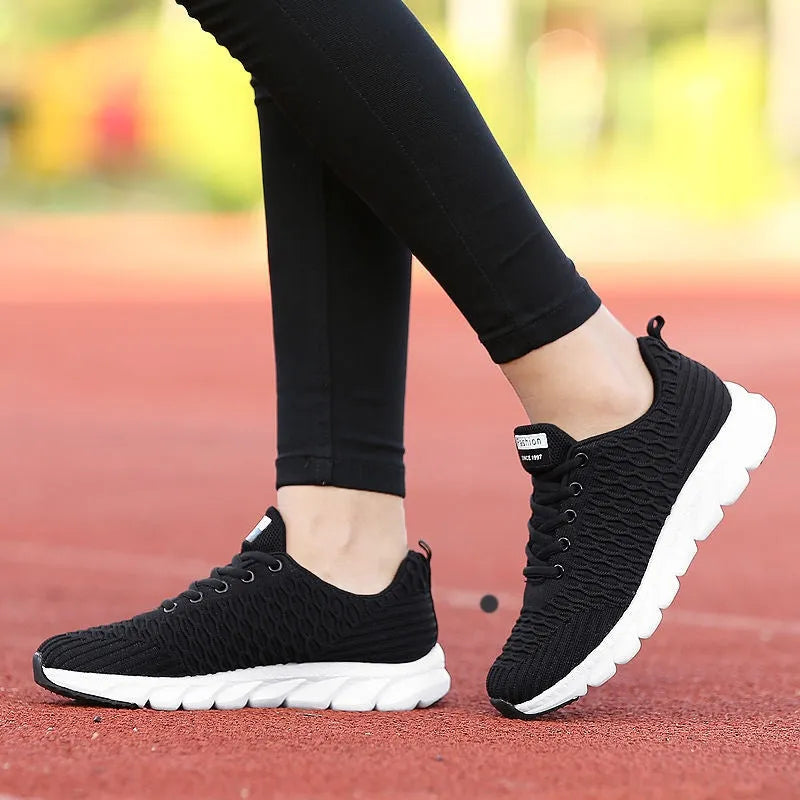 Women's running shoes with mesh upper in black, pink, or white colour options