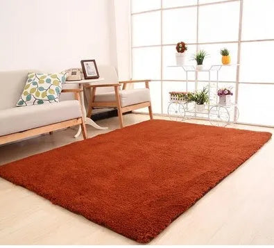 Solid colour fluffy plush carpet with non-slip dots on bottom, shown in beige on a wooden floor.