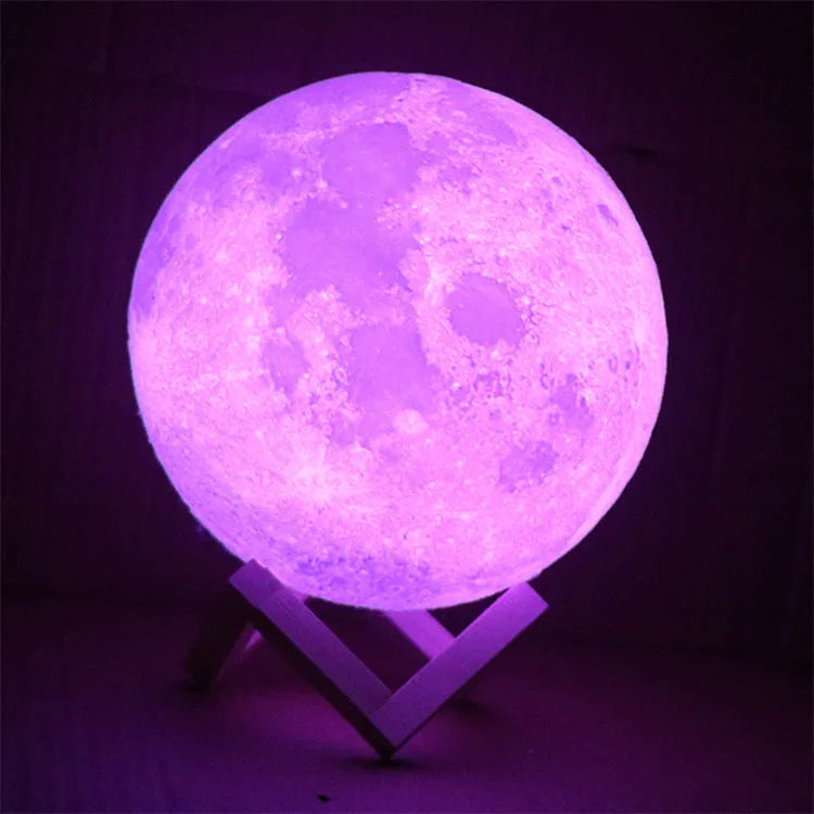 3D printed white moon lamp on wooden stand showing detailed lunar surface texture.