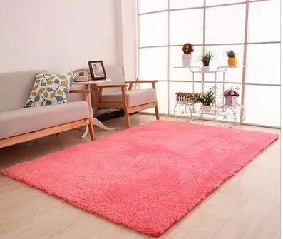 Solid colour fluffy plush carpet with non-slip dots on bottom, shown in beige on a wooden floor.