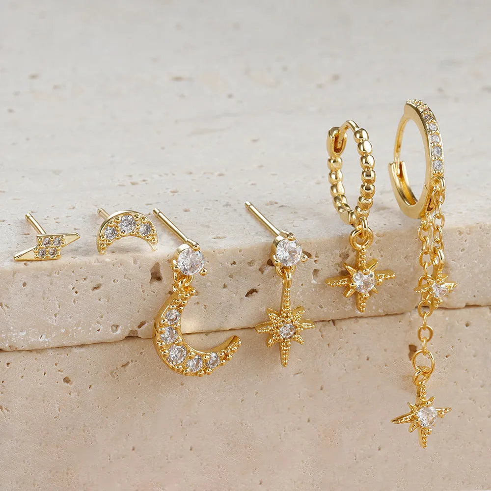 XINGX gold chain tassel earrings set with zircon stud accents, six individual pieces shown